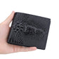 Men’s short wallet held in hand, dark crocodile-print design with embossed logo.