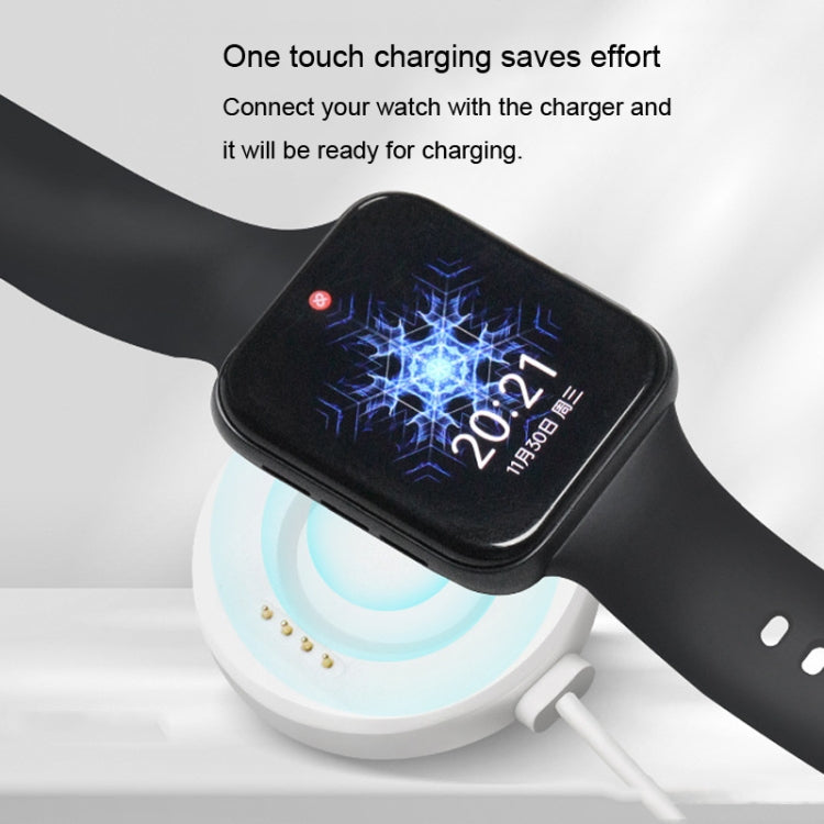 Black magnetic watch charging dock with USB cable connected to smartwatch