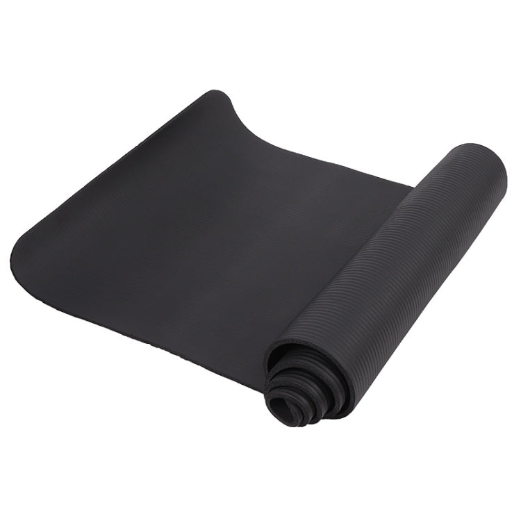 Black rolled yoga mat with textured grip surface
