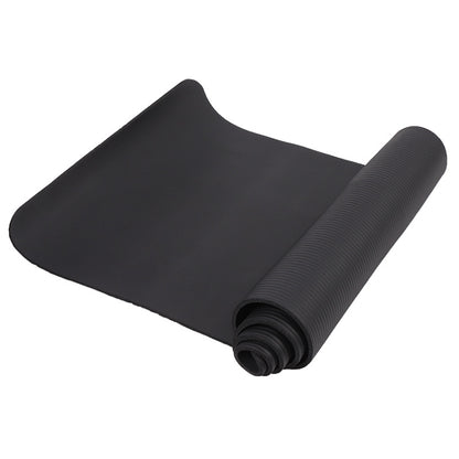 Black rolled yoga mat with textured grip surface