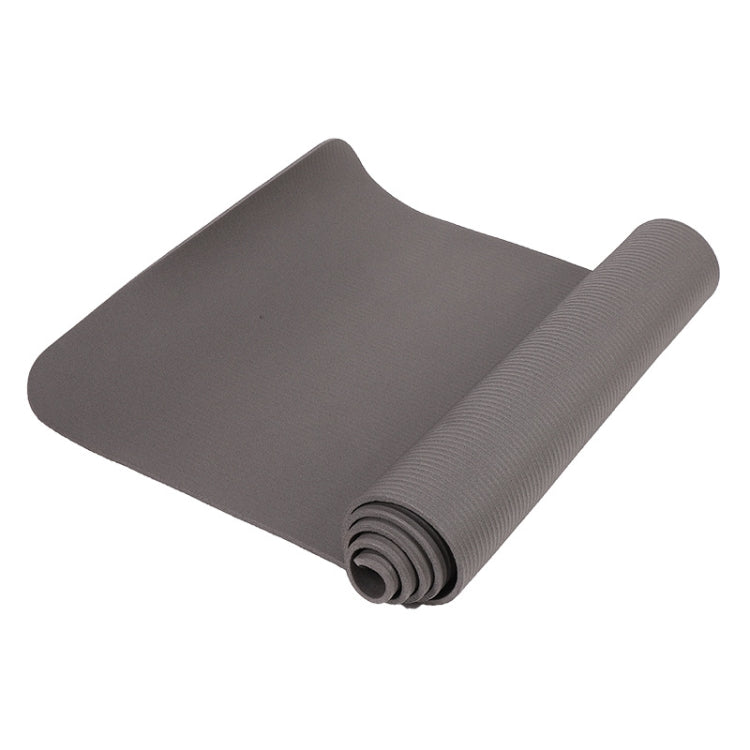 Gray rolled yoga mat with textured grip surface