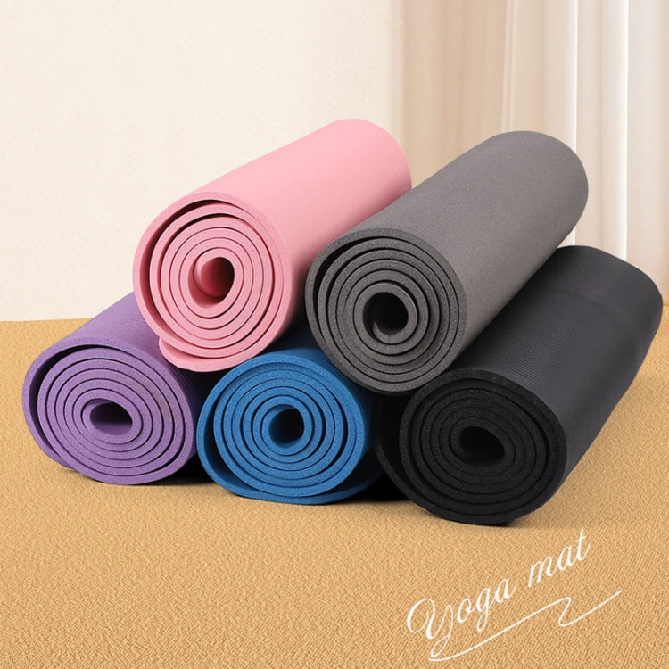Color assortment of rolled yoga mats: pink, gray, purple, blue, and black