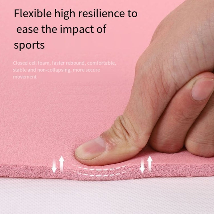 Pink yoga mat surface pressed by a hand, cushioned and flexible