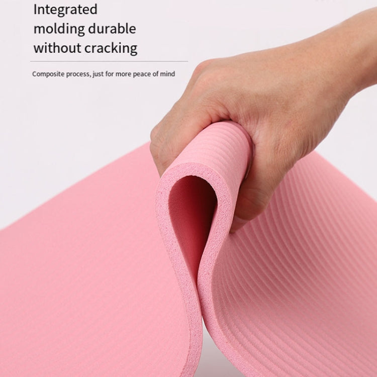 Pink yoga mat edge showing ribbed texture and rolled cushioning