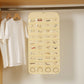 Light yellow hanging jewelry organizer bag with clear compartments and ring sections