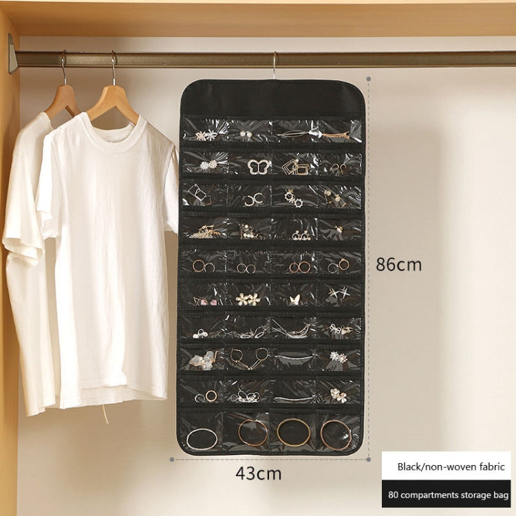 Black hanging jewelry organizer bag with clear window compartments for jewelry