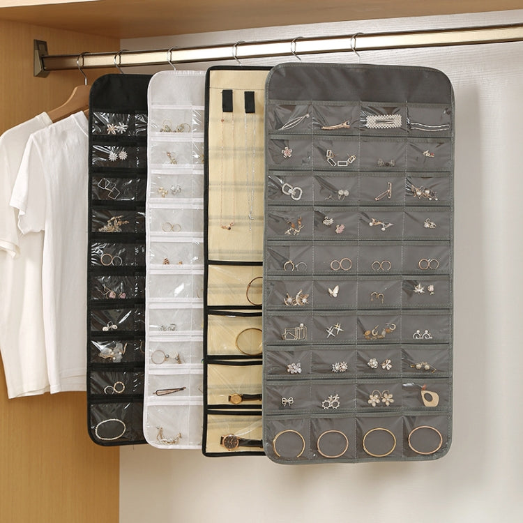 Hanging jewelry organizer bags in black, white, and gray with clear pockets