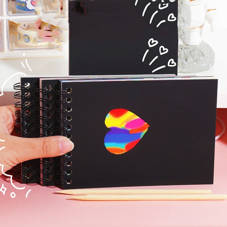 Black scratch art notebook pages with spiral binding and colored scratch pen tip