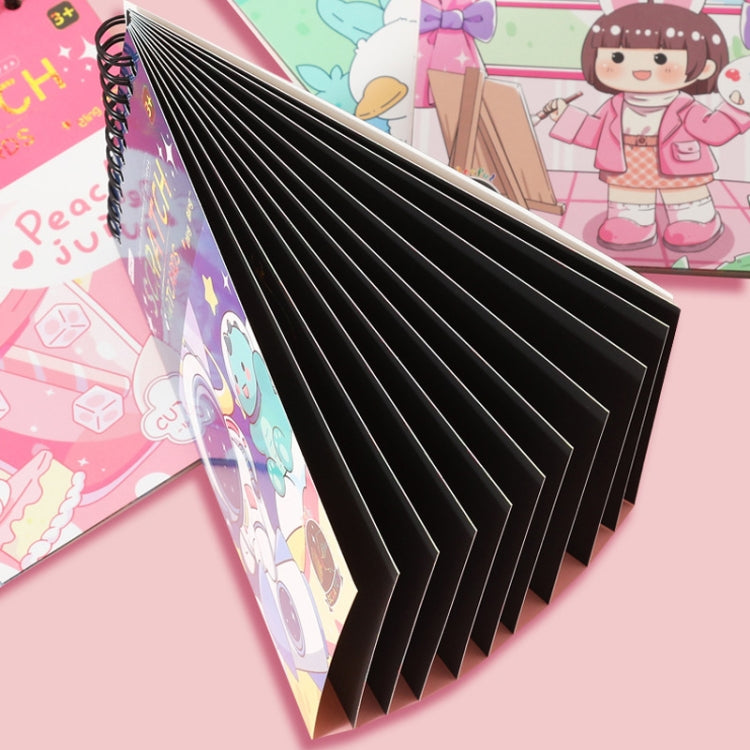 Folded scratch art notebook with spiral binding showing stacked black scratch pages