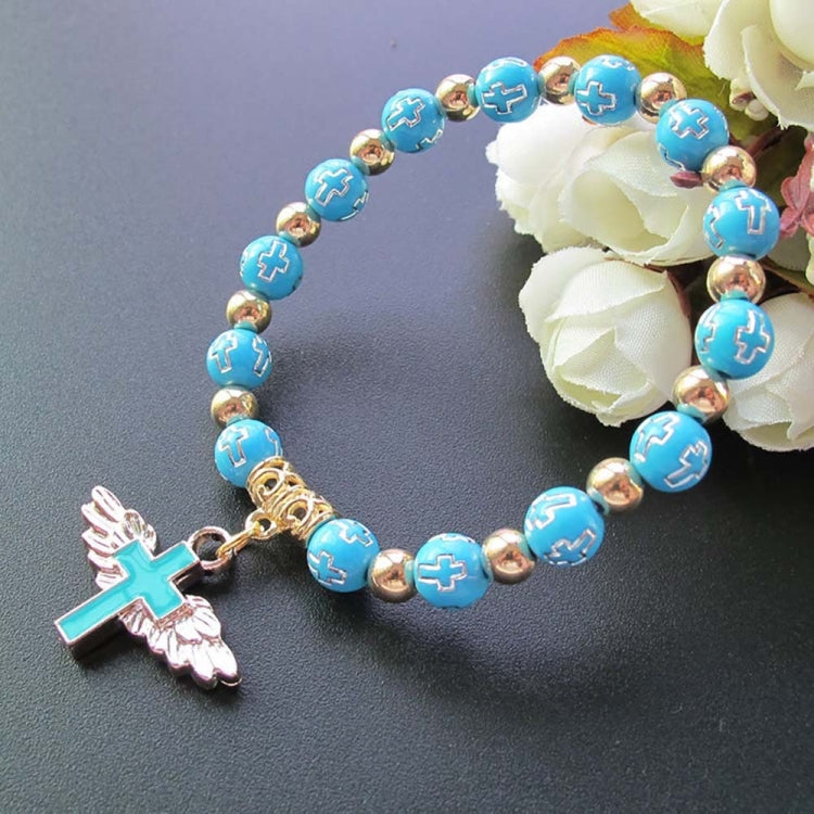 Blue bead angel cross bracelet with gold spacers and white angel cross charm.