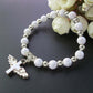 Silver-tone bead angel cross bracelet with gold spacers and angel cross charm.