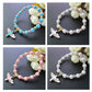 Angel cross bead bracelet color variants: blue, white, pink, and silver charm views.