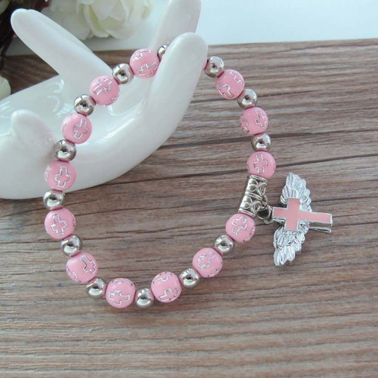 Pink bead angel cross bracelet with gold spacers and silver angel cross charm.