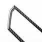 Black carbon-fiber style air outlet trim sticker piece, angled close-up