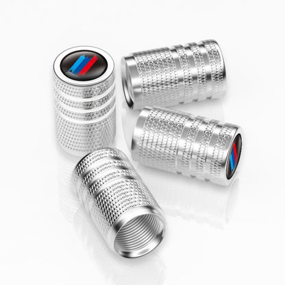 Silver checkered car wheel valve caps with tricolor logo accent