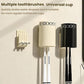 Toothbrush storage rack with cream and black cups and vertical toothbrush slots.