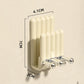 Cream wall-mounted toothbrush holder with chrome hooks; compact 7x4.1x2 cm size.
