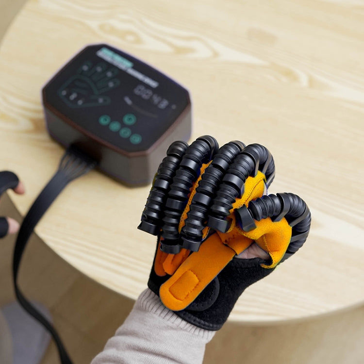 Robotic rehabilitation glove with black ribbed air tubes and orange finger pads on a hand