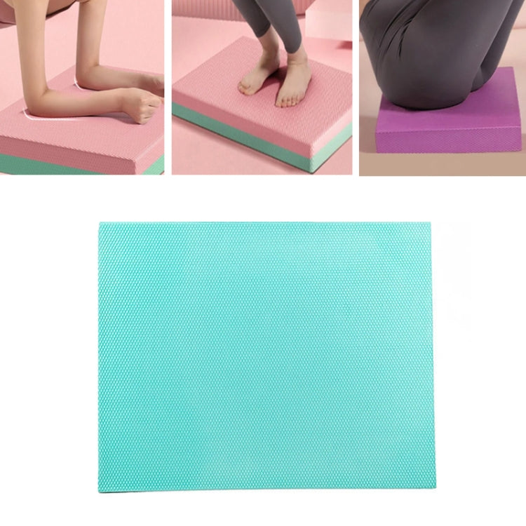 Purple fitness balance mat used for kneeling support during exercise.