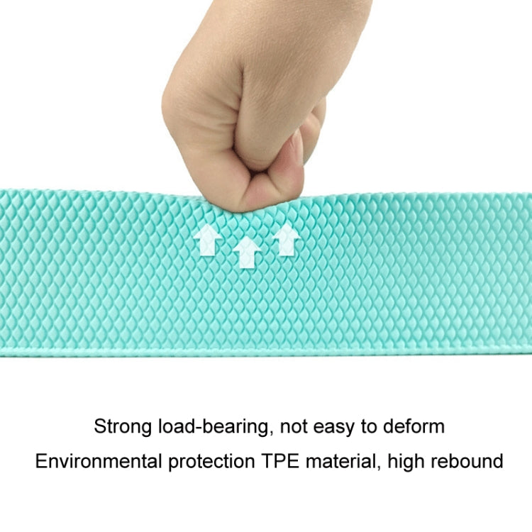 Turquoise balance mat with diamond non-slip texture, hand pressing to test firmness.