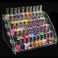 Transparent acrylic nail polish rack showing many bottles on clear tiered shelves