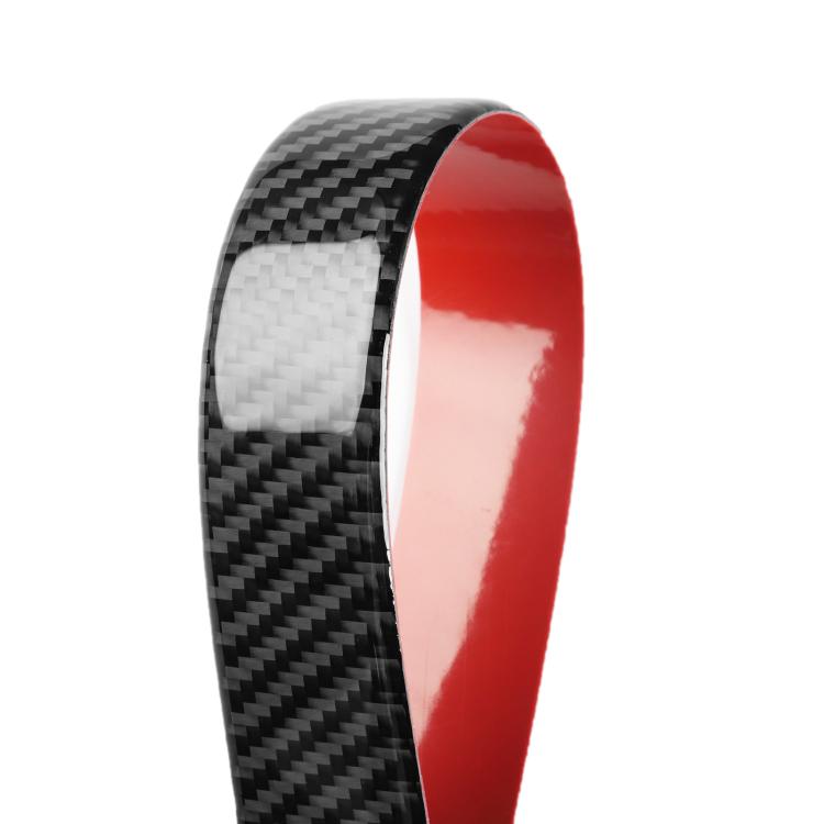 Carbon-fiber edge detail of a red-trim decorative sticker.