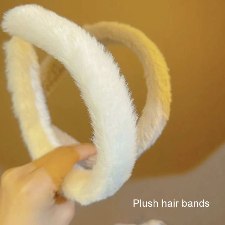 Cream plush headband with two soft loops held in hand