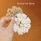 Pair of plush scrunchie hair bands in cream and beige tones