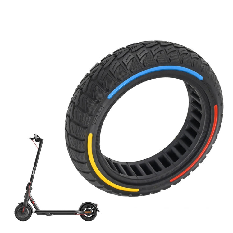 Off-road scooter tire, black tread with blue, yellow, and red sidewall stripes