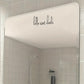 Vinyl mirror decorative sticker, black cursive “hello sweet cheeks” on a rectangular mirror