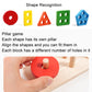 Wooden shape recognition blocks with colored bases and peg pillars; hand holding round piece