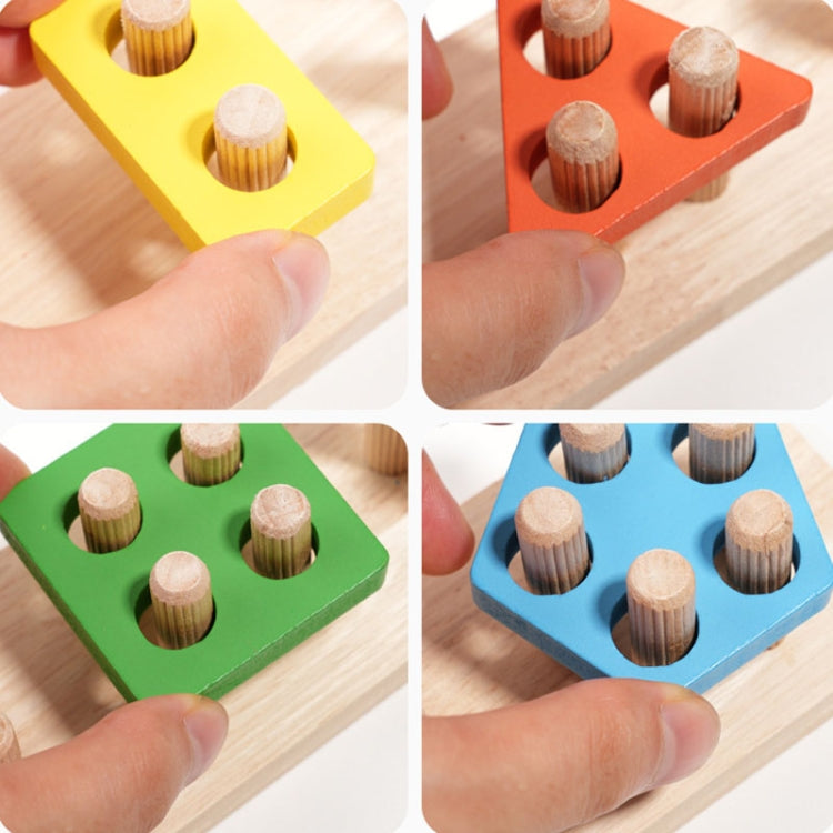 Hand placing peg pillars into a wooden shape base set in yellow, orange, green, and blue