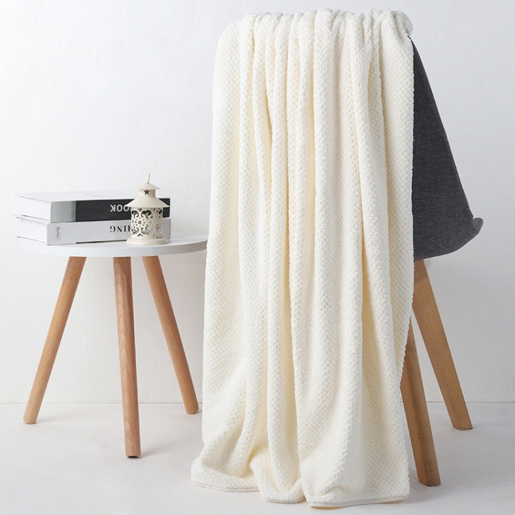 Off-white bath shower towel with waffle texture, neatly draped over chair