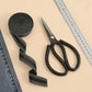 Iron-on pant leg tape stickers, dark gray roll and strip shown beside crafting tools