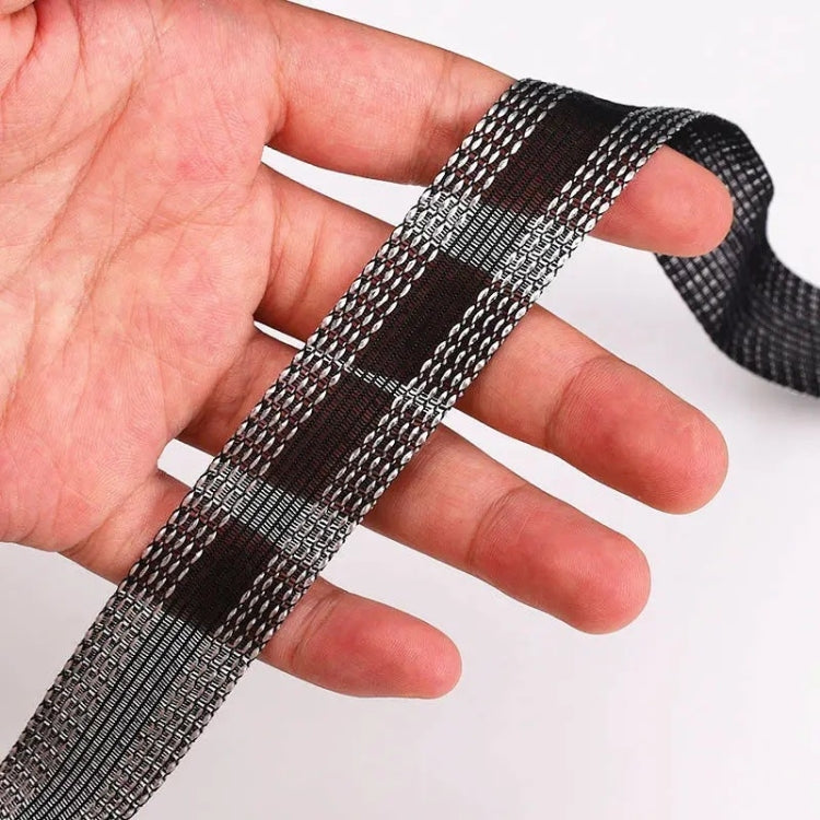 Iron-on pant leg tape stickers, black lattice stripe held in hand, flexible strip roll