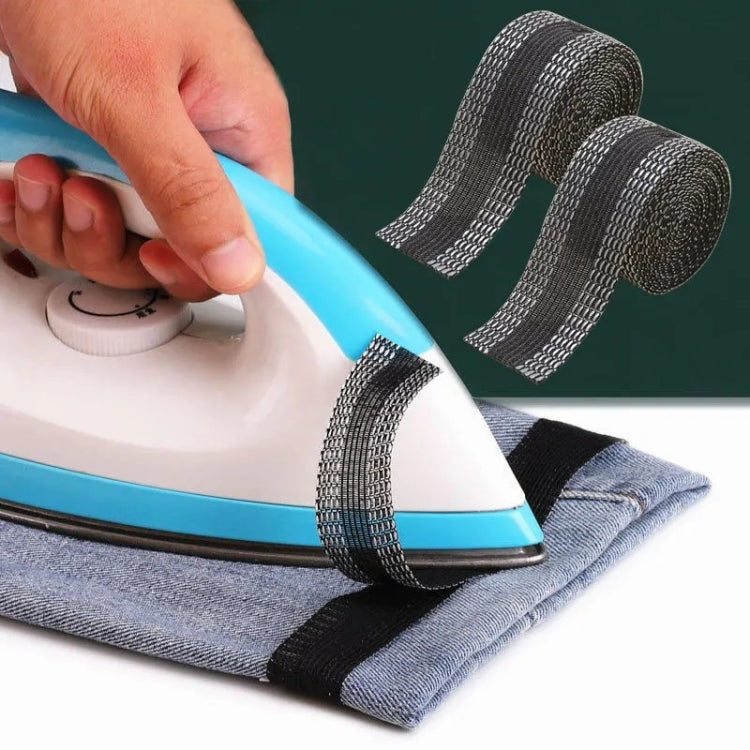 Self-adhesive iron-on pant leg tape strip, dark gray, applied to folded jeans