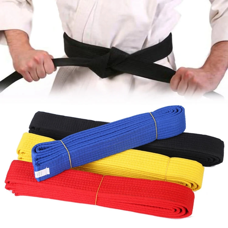 Rolled taekwondo belts in black, blue, yellow, and red