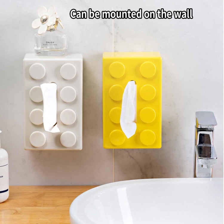 Yellow building-block tissue box wall-mounted with tissue opening and round studs