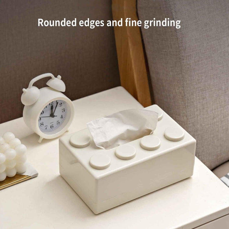 White building-block tissue storage box on tabletop with tissue peeking from slot