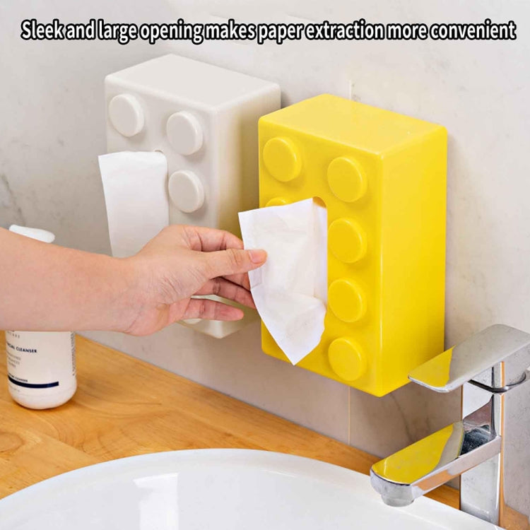 Yellow building-block style tissue box with circular details, open front holding tissues