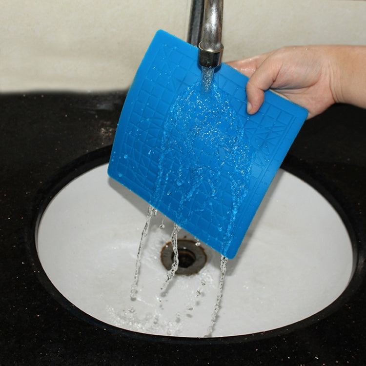 Blue silicone 3D pen template mat being rinsed under running water