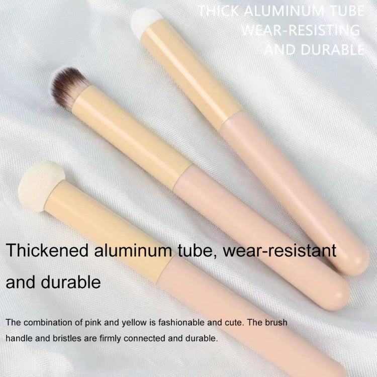 Two pastel concealer brushes with thick aluminum-style tubes and dense bristles