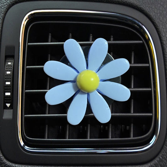 Blue daisy air vent aromatherapy clip with yellow center, attached to car vent