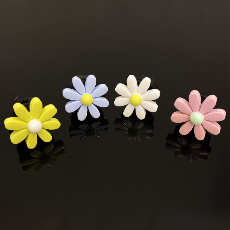 Set of four daisy air vent clips in yellow, light blue, white, and pink