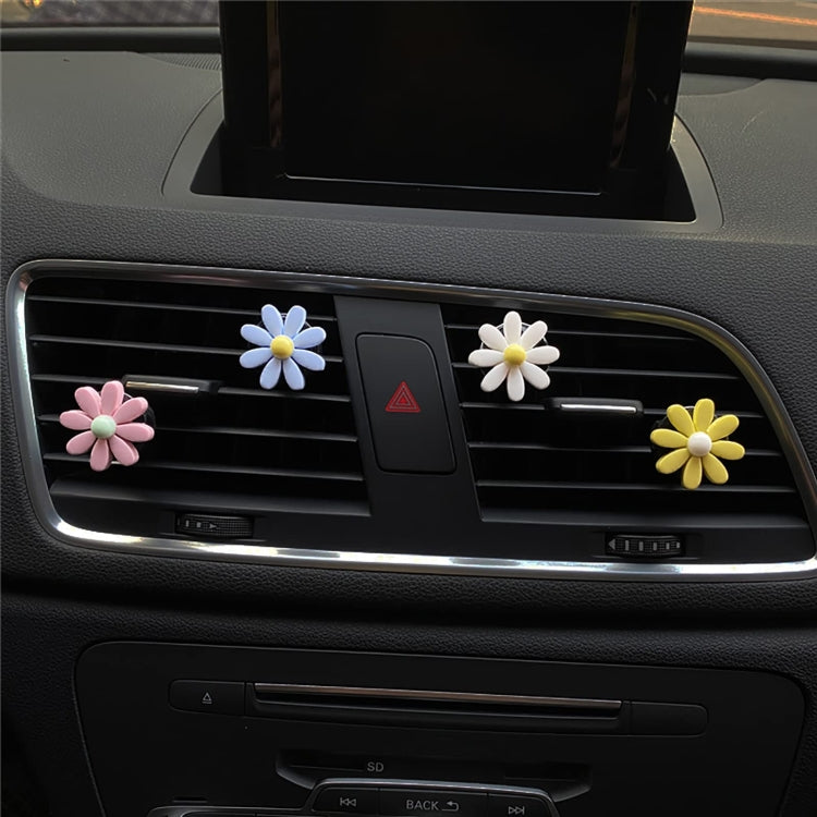 Assorted daisy air vent clips on car dashboard vent with five-petal flowers