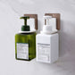Wall-mounted soap dispenser holders for bottles, white and green pump bottles shown