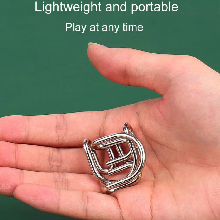 Small shiny metal nine-link puzzle piece held in a hand