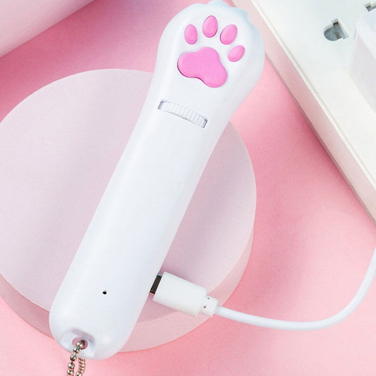 White USB rechargeable LED pet projector toy with pink paw icon connected by charging cable