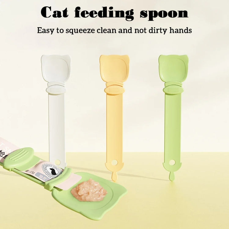 Set of cat feeding spoons with hinged scoop heads in cream, orange, and green.