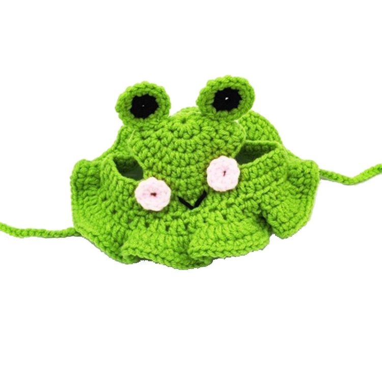 Green knitted frog hat, flat view with black eyes and pink cheeks